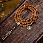 Tibetan-9-Eye-Dzi-Pendant-with-Aged-Star-Moon-Bodhi-Mala-–-Sacred-Necklace-for-Wisdom-and-Power