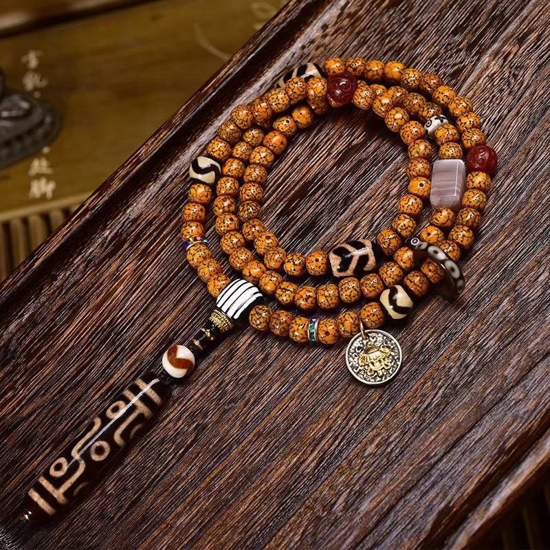 Tibetan-9-Eye-Dzi-Pendant-with-Aged-Star-Moon-Bodhi-Mala-–-Sacred-Necklace-for-Wisdom-and-Power