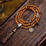 Tibetan-9-Eye-Dzi-Pendant-with-Aged-Star-Moon-Bodhi-Mala-–-Sacred-Necklace-for-Wisdom-and-Power