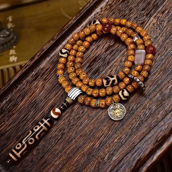 Tibetan-9-Eye-Dzi-Pendant-with-Aged-Star-Moon-Bodhi-Mala-–-Sacred-Necklace-for-Wisdom-and-Power