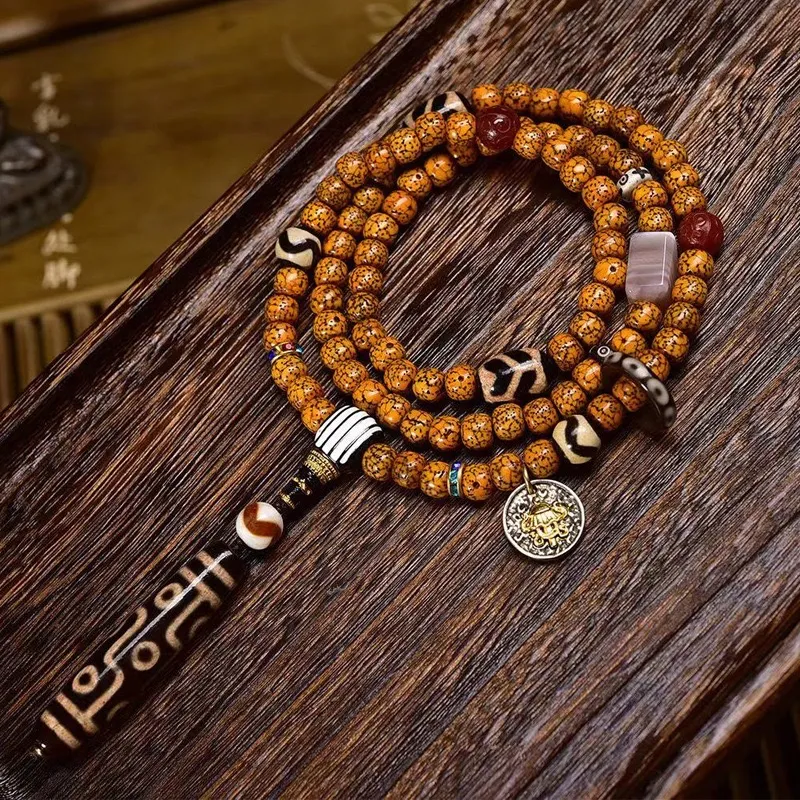Tibetan-9-Eye-Dzi-Pendant-with-Aged-Star-Moon-Bodhi-Mala-–-Sacred-Necklace-for-Wisdom-and-Power